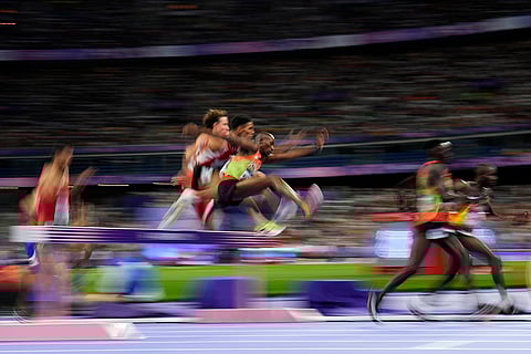 Runners compete in the men's 3000-meter steeplechase final